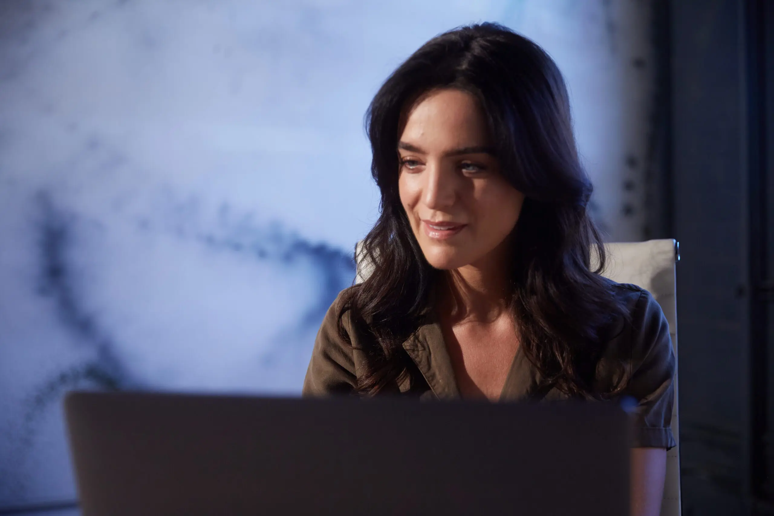 Woman staring at a laptop screen