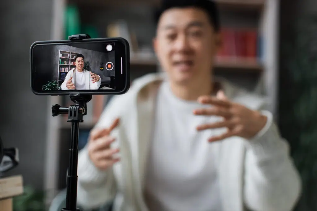 An actor filming a self-tape at home on their phone