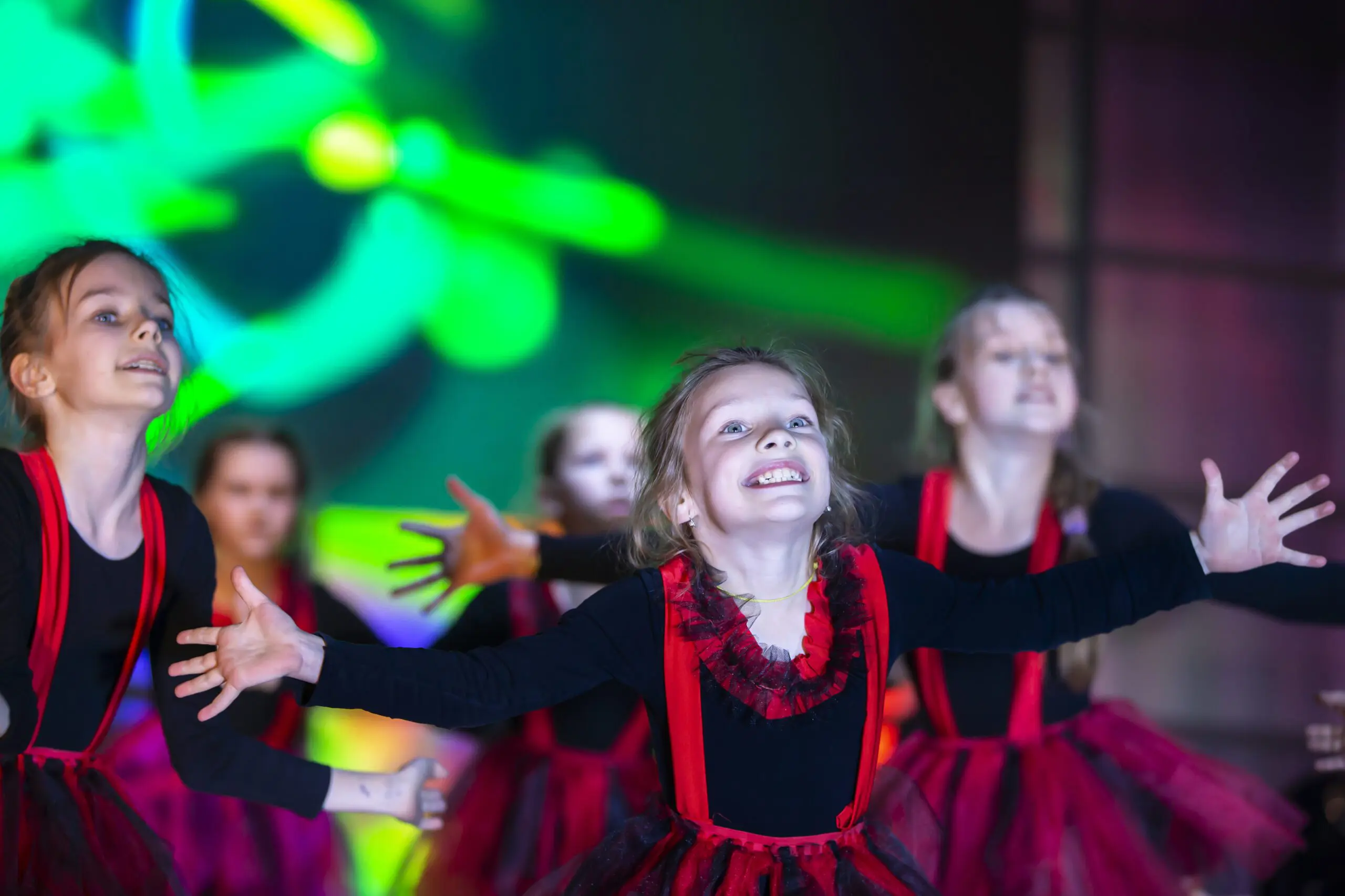 Five young performers dancing on stage