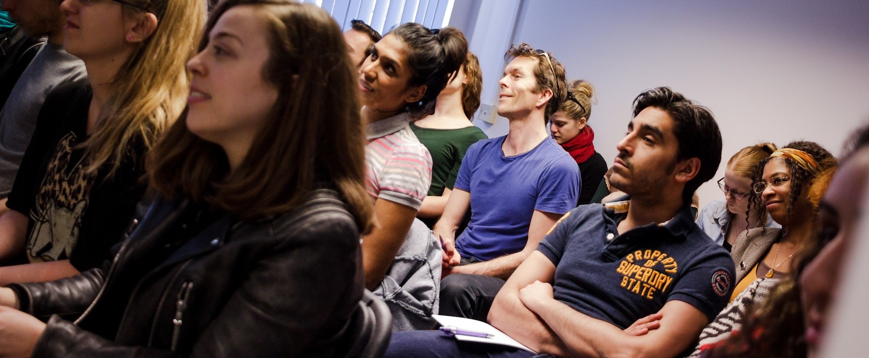 A group of young performers attends a reading.