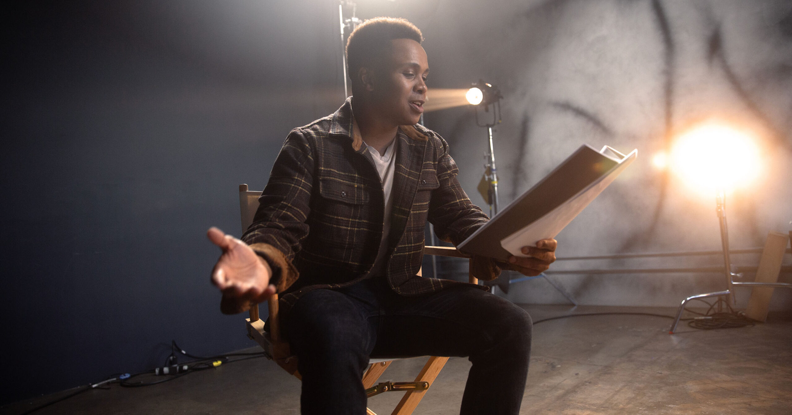 A young performer reads from a script.