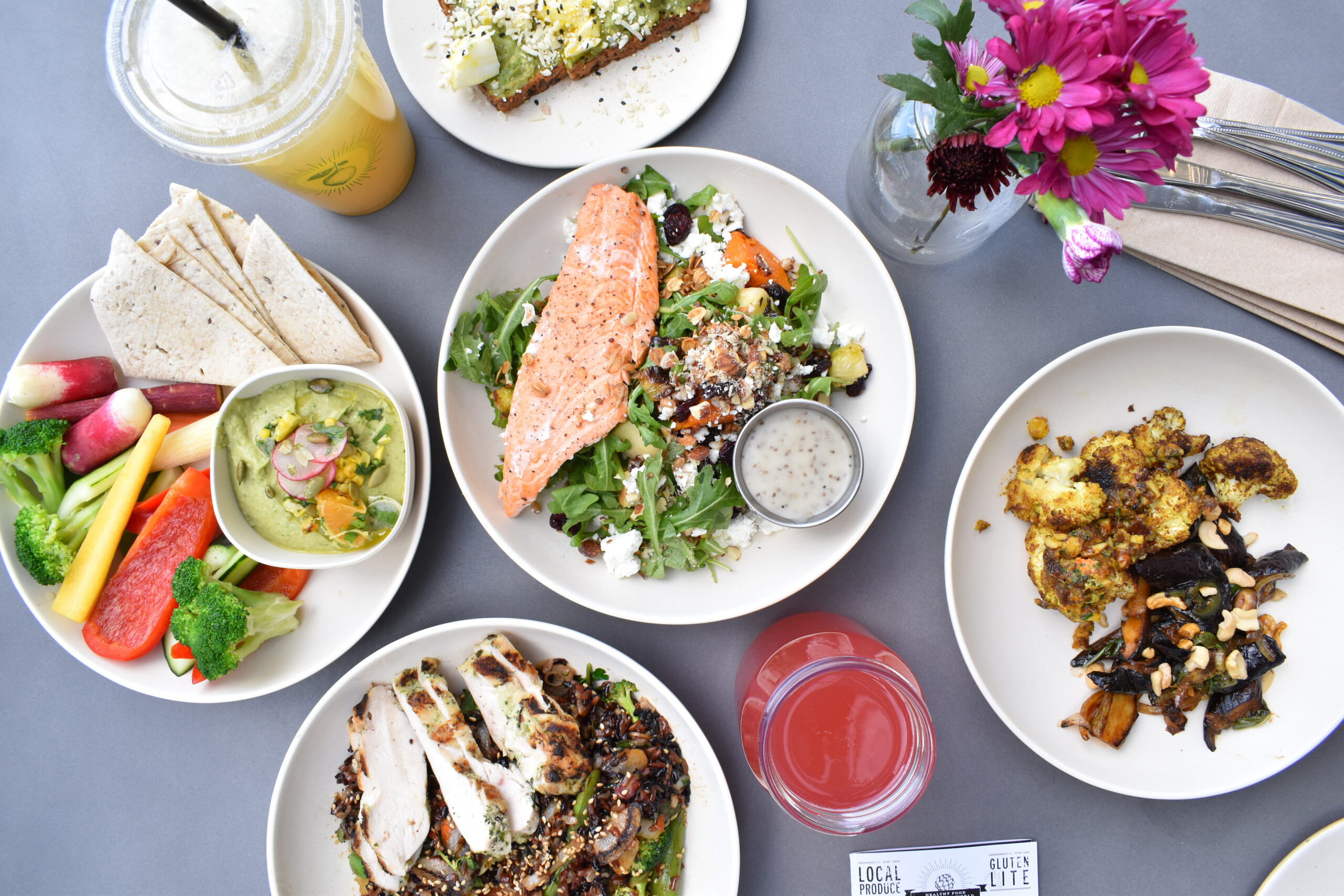 Various plates containing healthy meals on a table