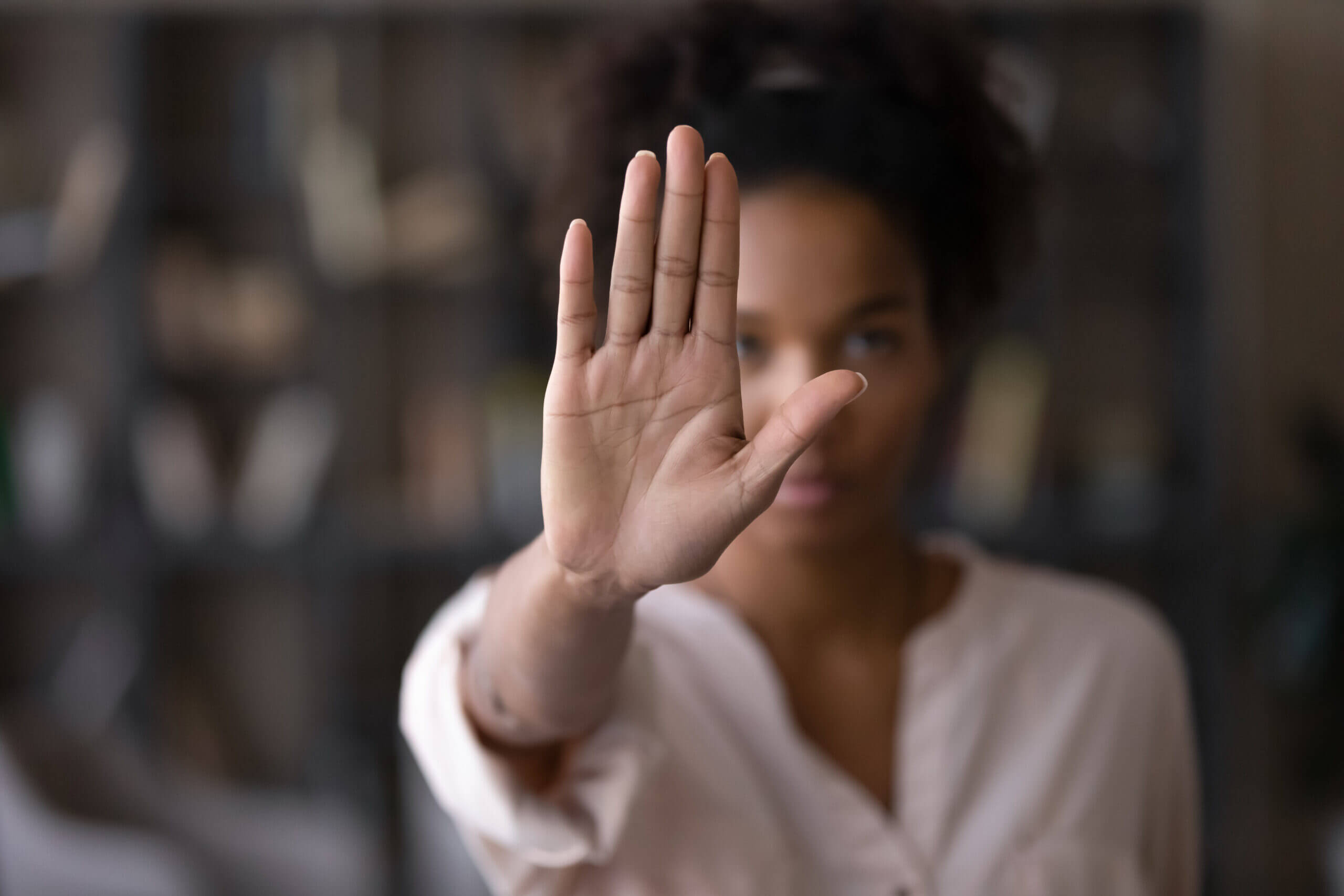 Woman holding her hand up in a stop gesture