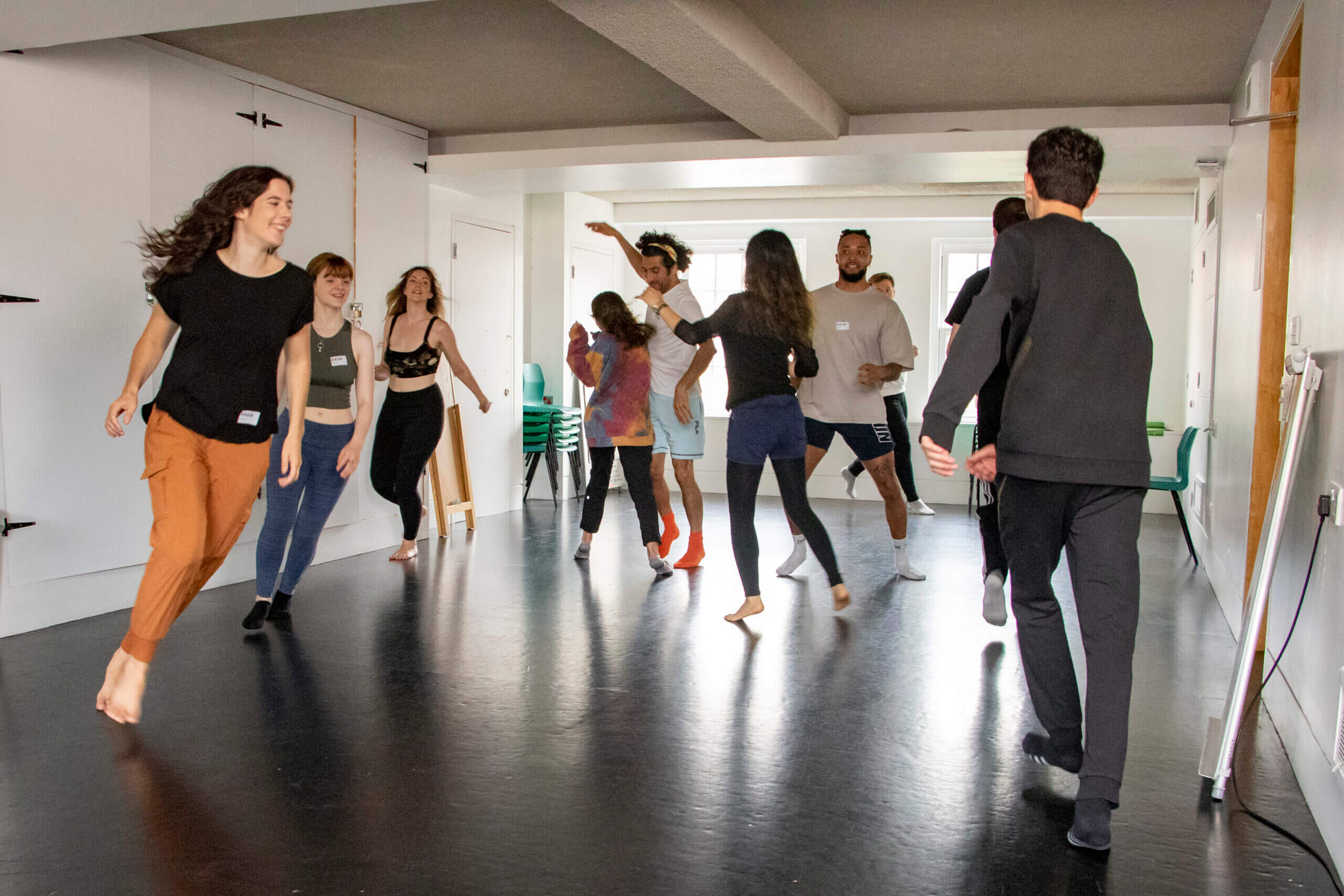 Actors running around the room participating in a short acting course at RADA