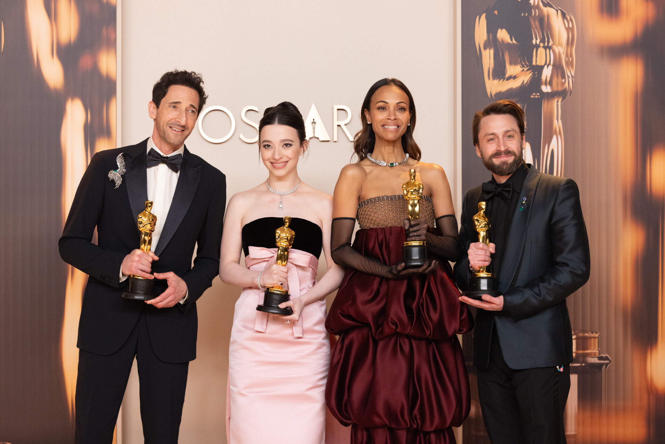 Adrien Brody, Mikey Madison, Zoe Saldaña and Kieran Cullen pose backstage with their Oscars
