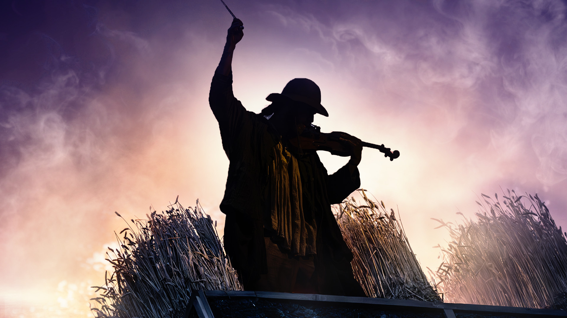 The silhouette of a man playing a fiddle in 'Fiddler on the Roof'