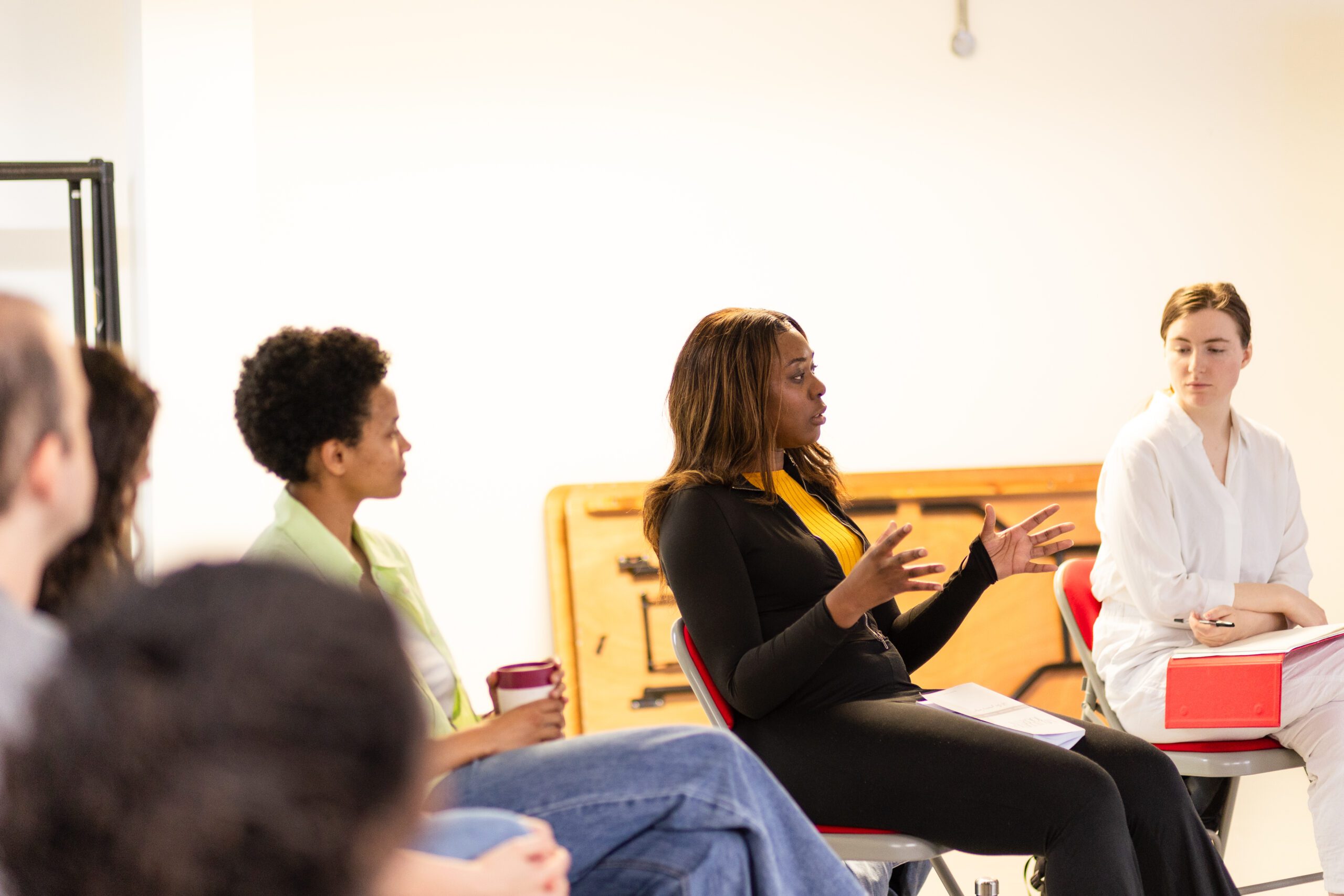 Actors sitting in chairs during a workshop