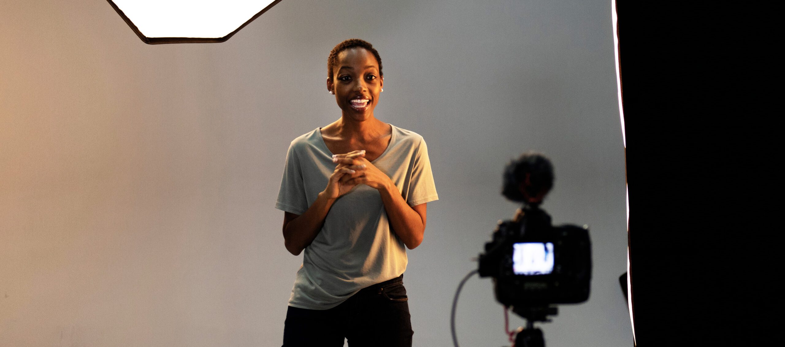 An actress filming a self-tape in a studio on a camera