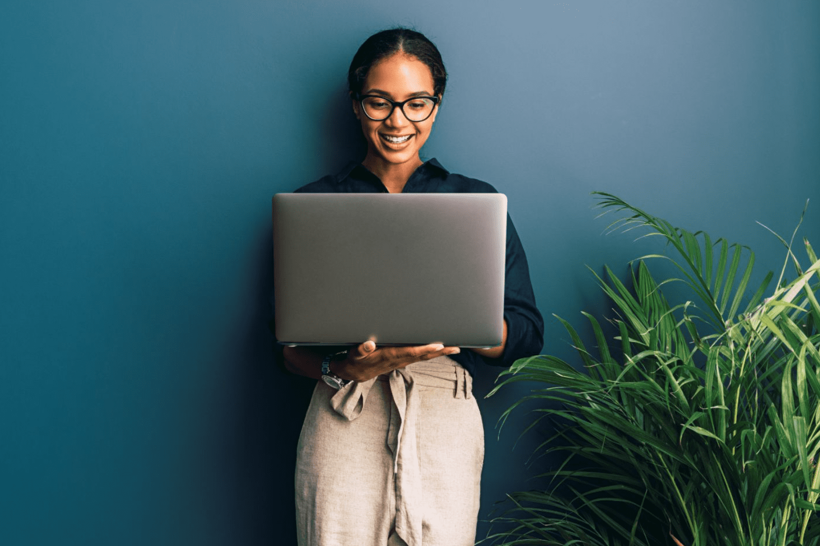 Woman staring down at a laptop in her hands